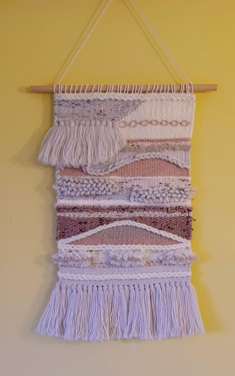 Abstract handwoven wall hanging in cream and pinks