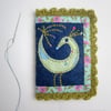 Needle case with appliquéd bird and crochet trim
