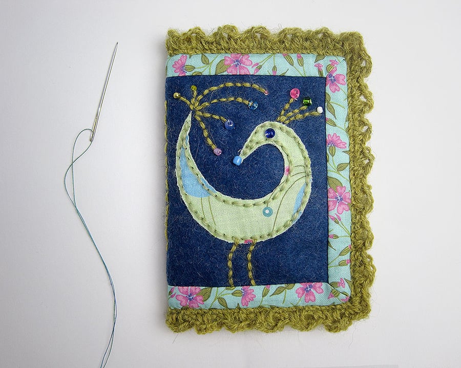 Needle case with appliquéd bird and crochet trim