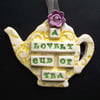Ceramic teapot decoration with button flower