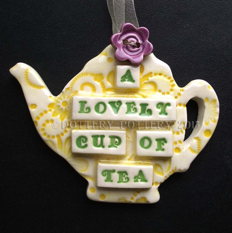Ceramic teapot decoration with button flower