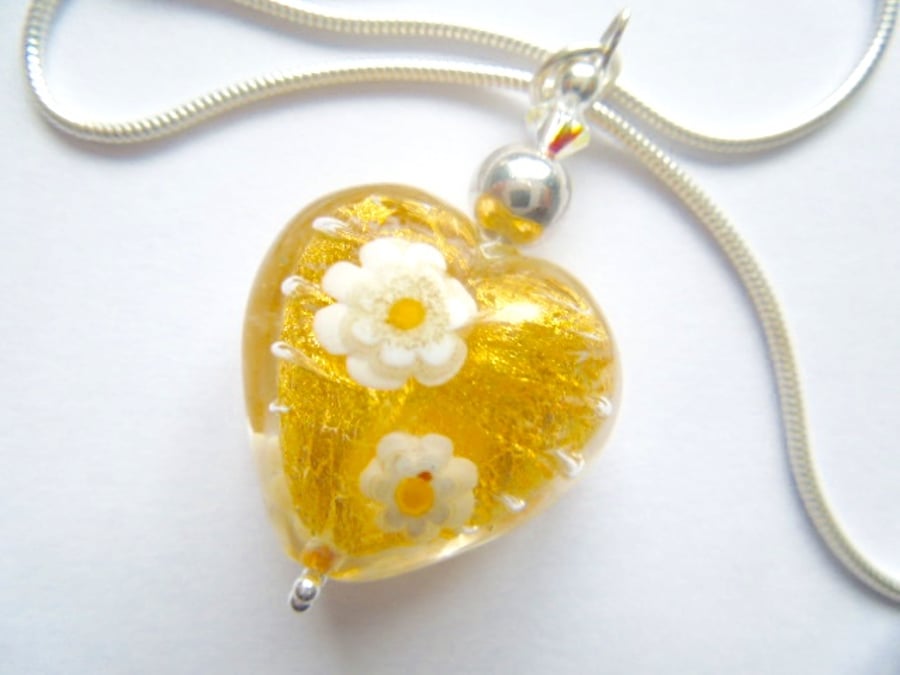 Gold daisy patterned Murano glass heart pendant with sterling silver.