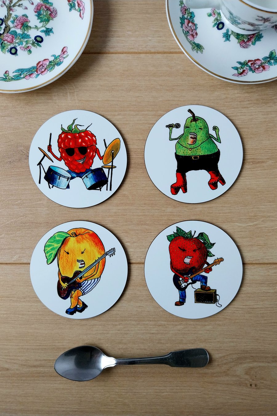 Set of four coasters with cartoon fruit characters playing instruments