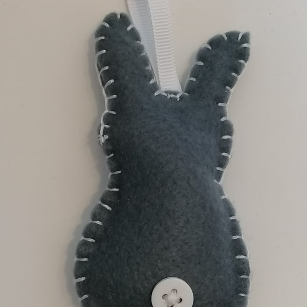 Handmade grey felt rabbit with white stitching, ribbon and button 