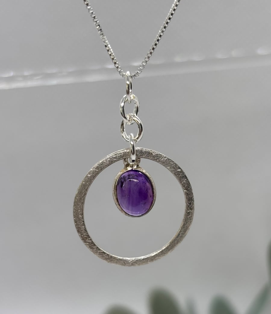 Silver circle pendant with amethyst