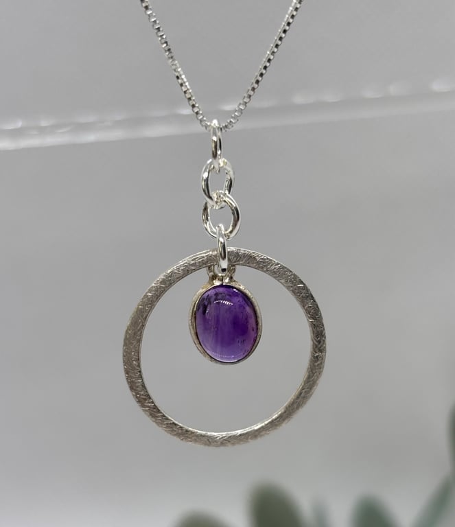 Silver circle pendant with amethyst
