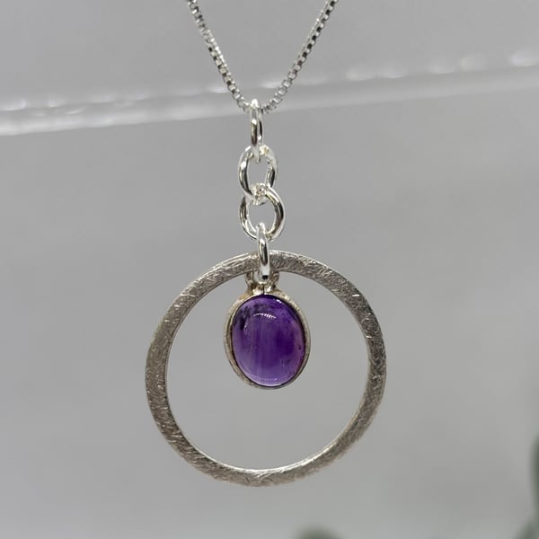 Silver circle pendant with amethyst