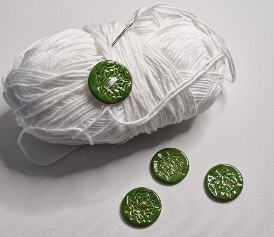 Set of four green handmade ceramic buttons.