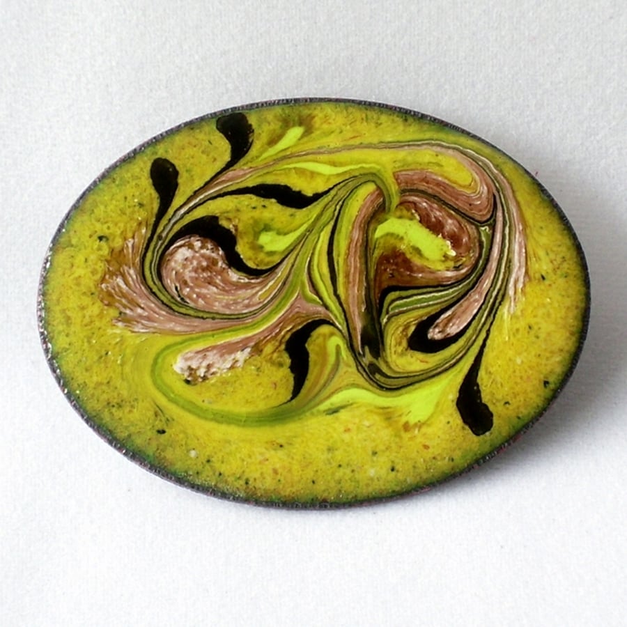 brooch - oval: scrolled black, pink, and white on yellow