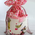 Drawstring bag with pockets printed with birds and bird boxes
