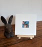 Mounted Resting Whimsical Hare Rabbit with Blue Wildflowers Watercolour Print - Image 4