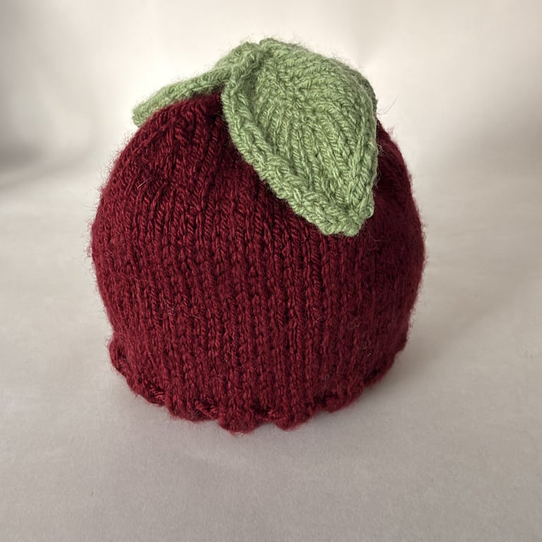 Children's hand knitted hat with leaf decoration