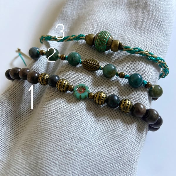 Set of three Green And Antique Brass Coloured Bracelets