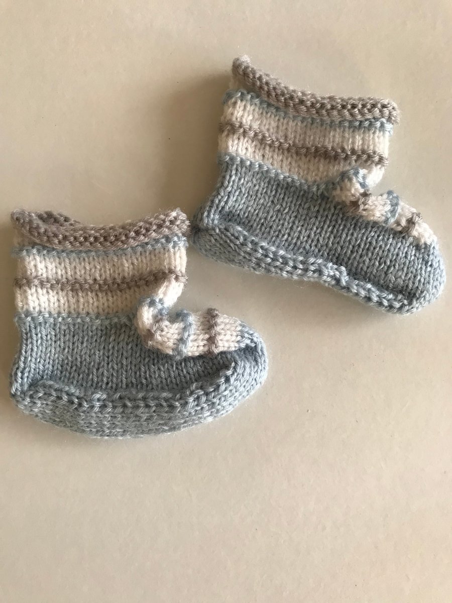 Three coloured hand knitted baby bootees