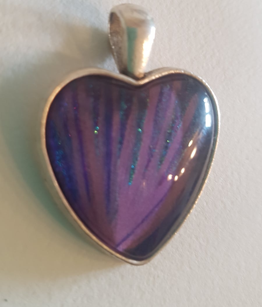 Heart shaped pendant,with tones of purple, lilac and aqua blue.