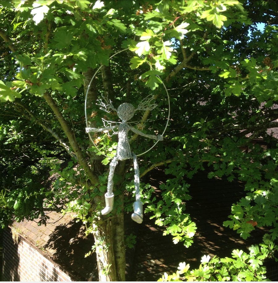 Garden fairy on a swing