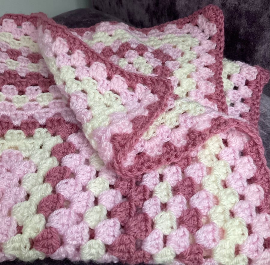 Granny square crochet blanket in a mix of pinks 