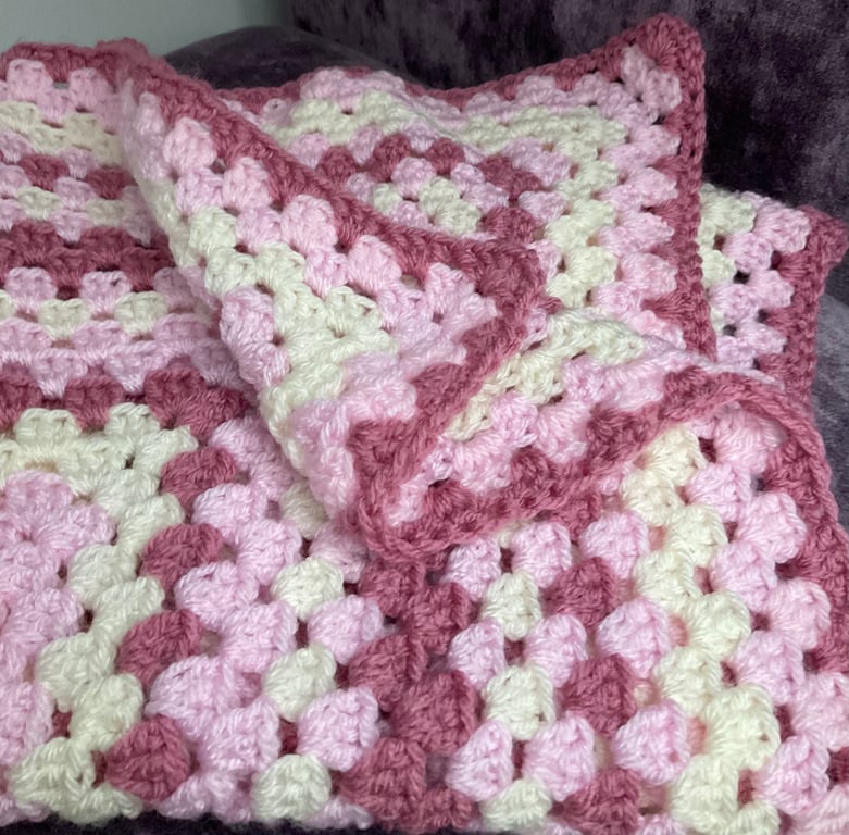 Granny square crochet blanket in a mix of pinks 