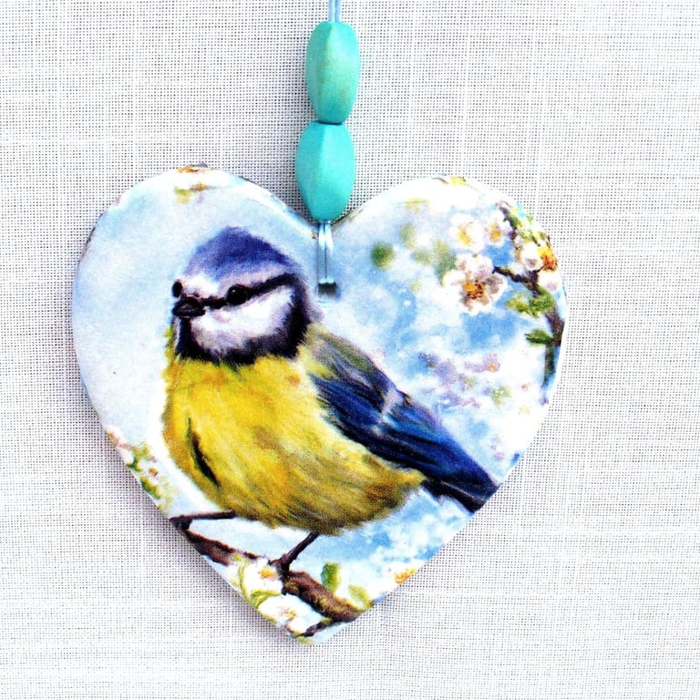 Decoupaged blue tit on a ceramic heart wall decoration.Ceramic