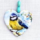 Decoupaged blue tit on a ceramic heart wall decoration.Ceramic