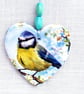 Decoupaged blue tit on a ceramic heart wall decoration.Ceramic