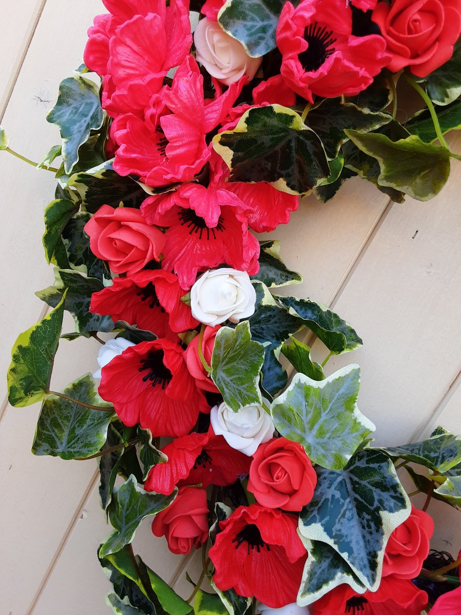 Maisie,  42cm crescent wreath, red,green and white. 