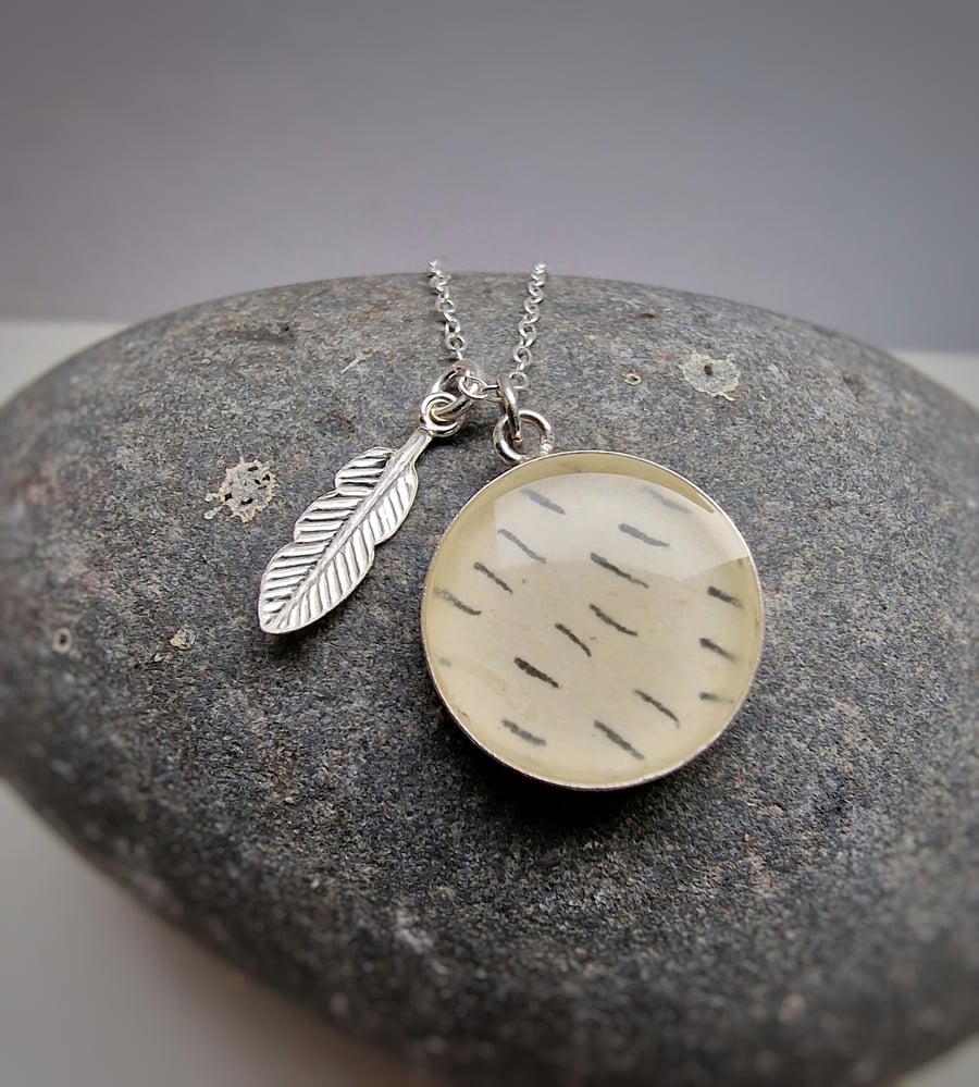 Beautiful sterling silver and resin pendant with  silver feather charm