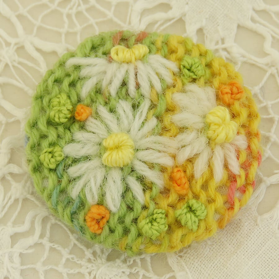 Daisy Brooch embroidered on knitted citrus background