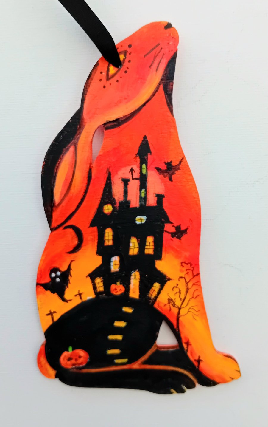 Halloween hare in orange  with spooky castle too