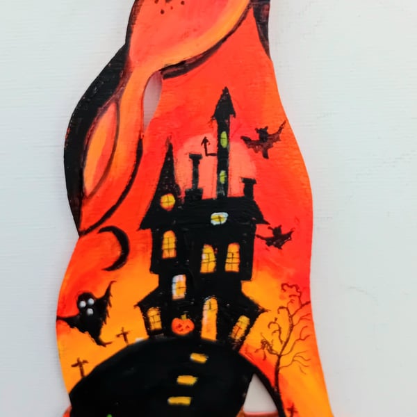 Halloween hare in orange  with spooky castle too