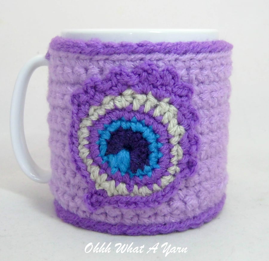 Crochet lilac peacock feather mug cosy, mug hug