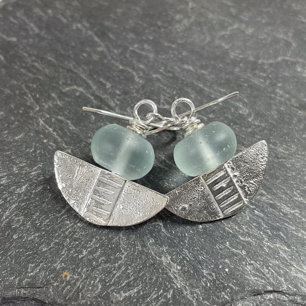 Silver and aqua glass tribal blade earrings.