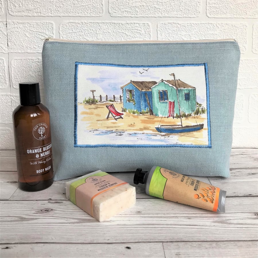 Beach huts toiletry bag, wash bag in pale blue with panel featuring beach huts