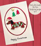 Christmas card, sausage dog in Santa hat and xmas jumper. To or from the dog. 