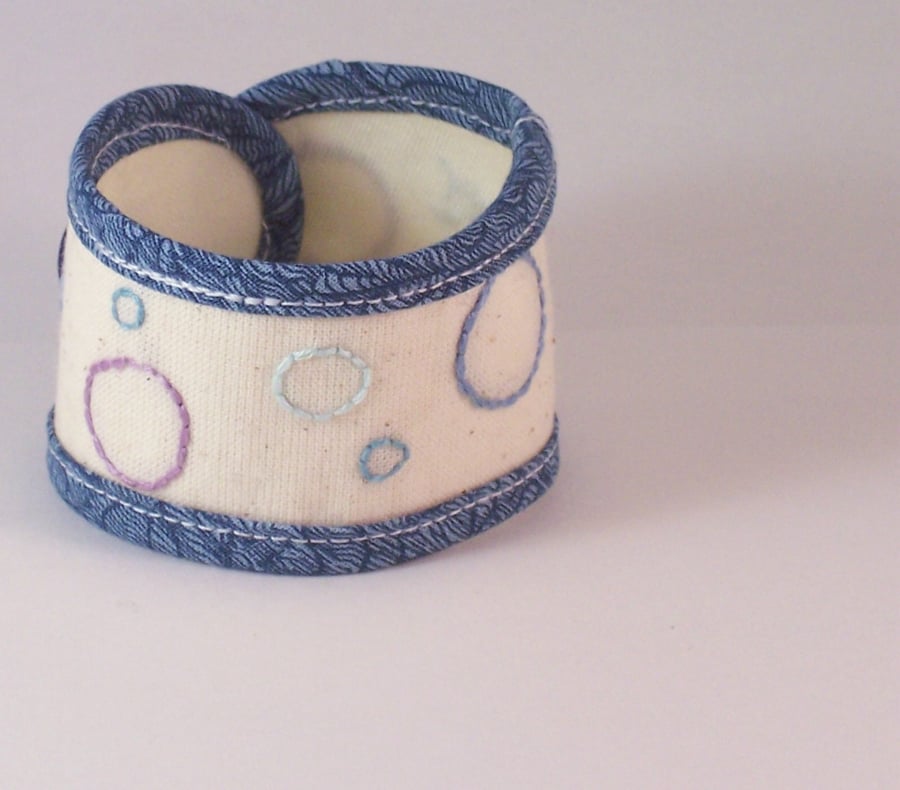 Hand embroidered soft fabric cuff in cream and blue