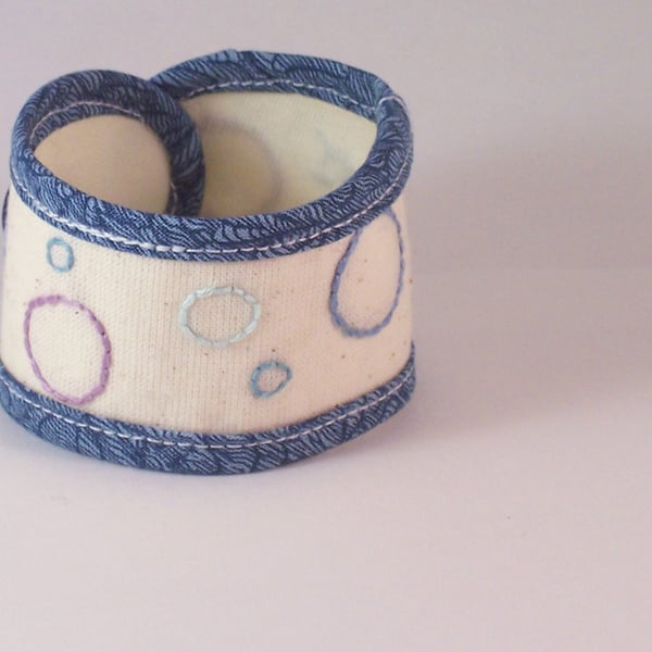 Hand embroidered soft fabric cuff in cream and blue