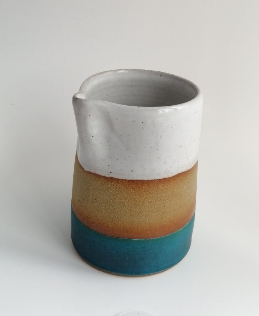 Handmade thrown stoneware pottery jug in white and blue-green glaze