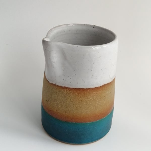 Handmade thrown stoneware pottery jug in white and blue-green glaze