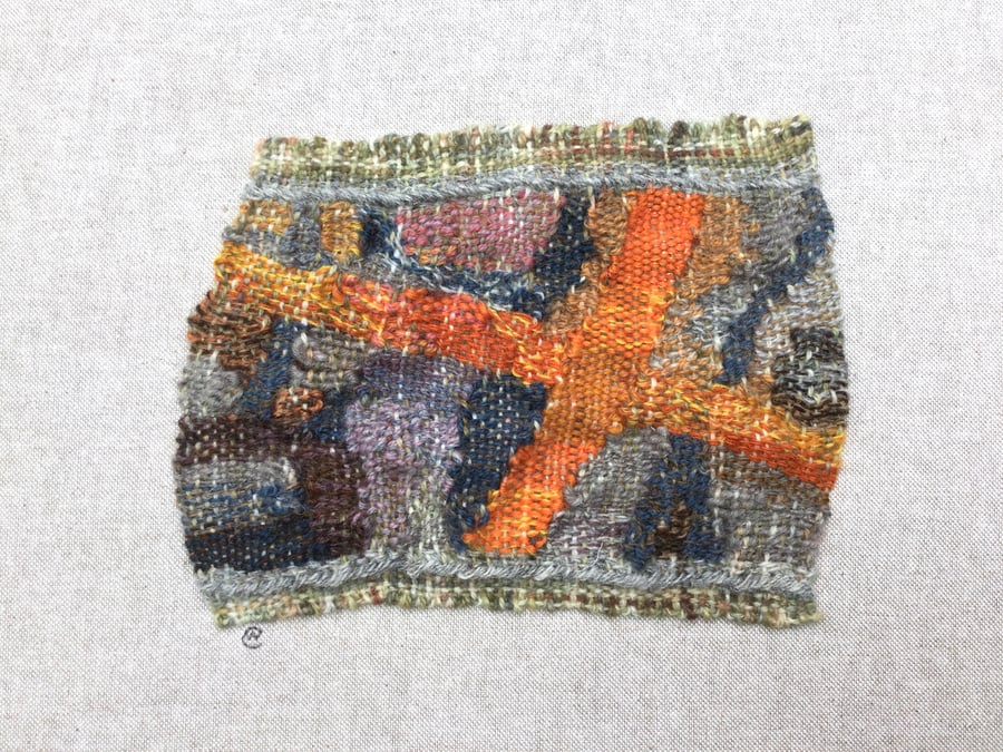 Framed handwoven tapestry weaving, textiles in orange, grey, blue and pink