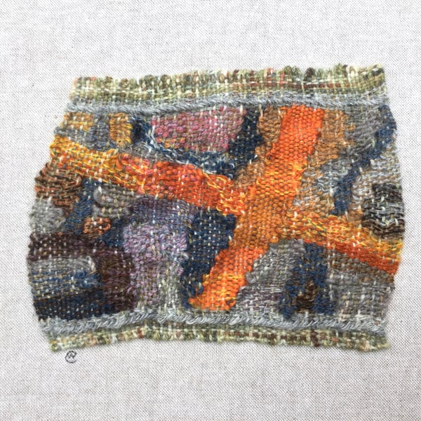 Framed handwoven tapestry weaving, textiles in orange, grey, blue and pink