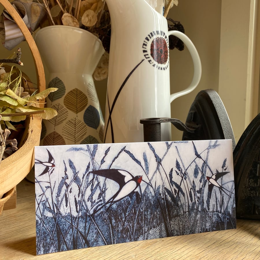 Greetings Card. Swallows over grassland.