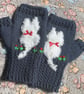 Navy blue mittens with a cat on and added flower embroidery