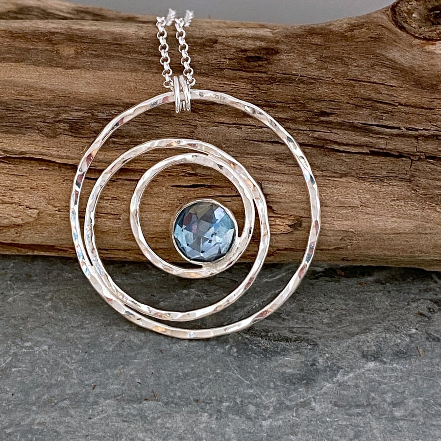 Silver circles necklace set with a blue Topaz gemstone 