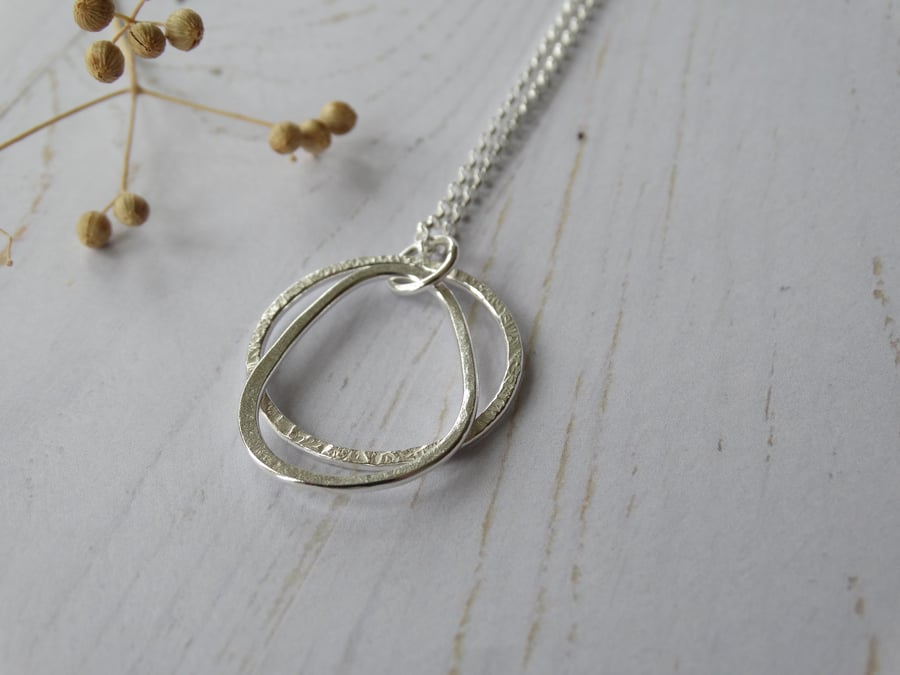Textured hoop and pebble pendant in recycled sterling silver on long chain