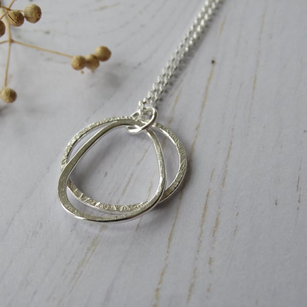 Textured hoop and pebble pendant in recycled sterling silver on long chain