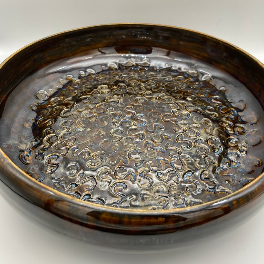 Large decorative bowl with 'S' design inside