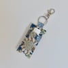 Key ring lip balm holder in modern floral print.