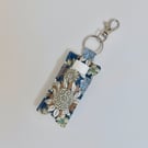 Key ring lip balm holder in modern floral print.
