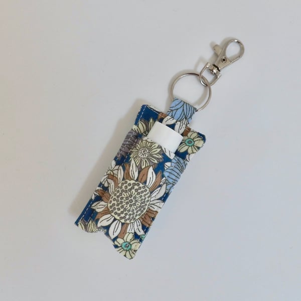 Key ring lip balm holder in modern floral print.