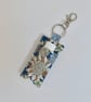Key ring lip balm holder in modern floral print.